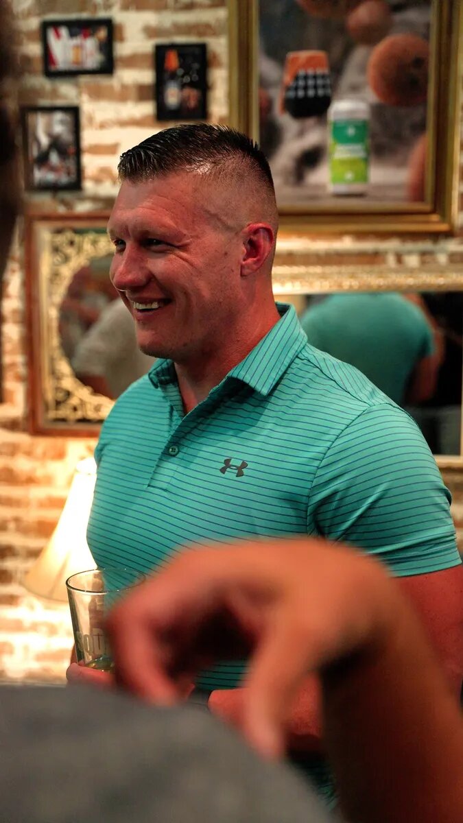 A dad smiling during a conversation at Turning Point Beer