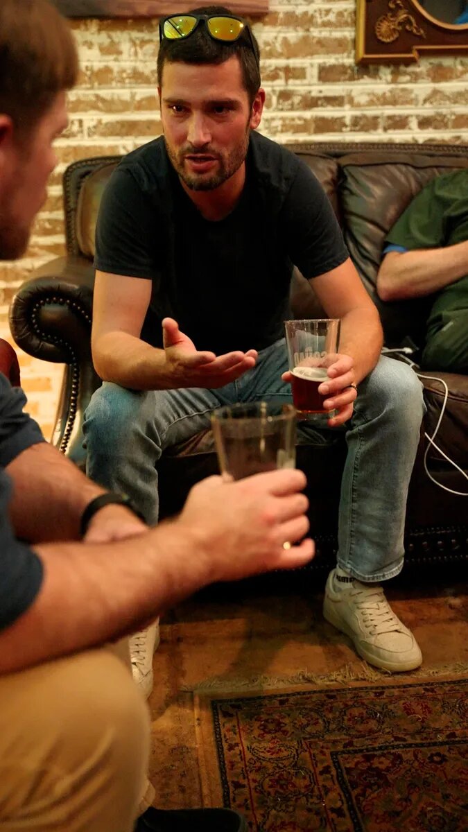 Dads sharing a conversation around the couches at Turning Point Beer