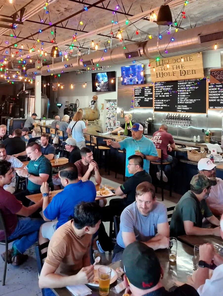 Local dads talking around full tables at False Idol Brewing