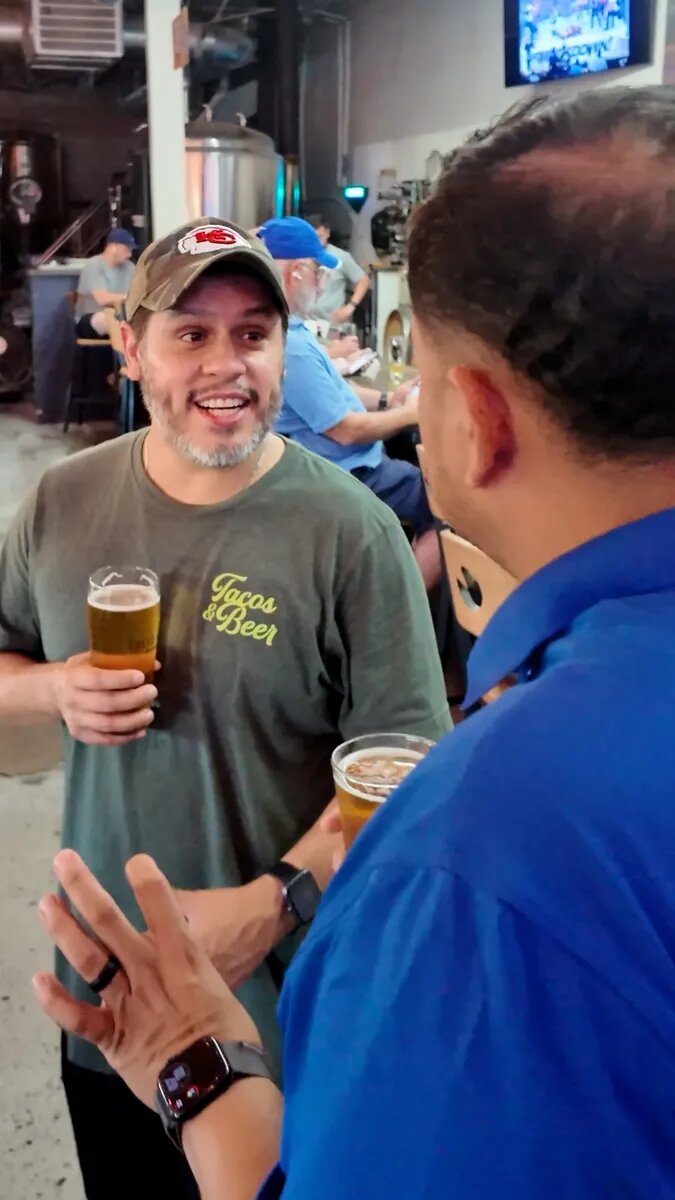 Two dads talking over drinks at False Idol Brewing