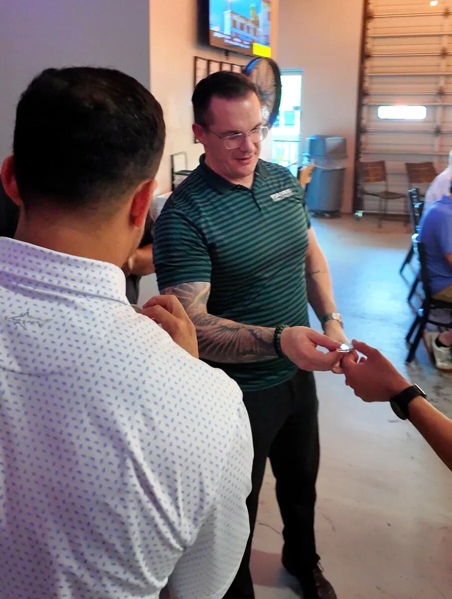 Dads talking beside the event check-in at False Idol Brewing