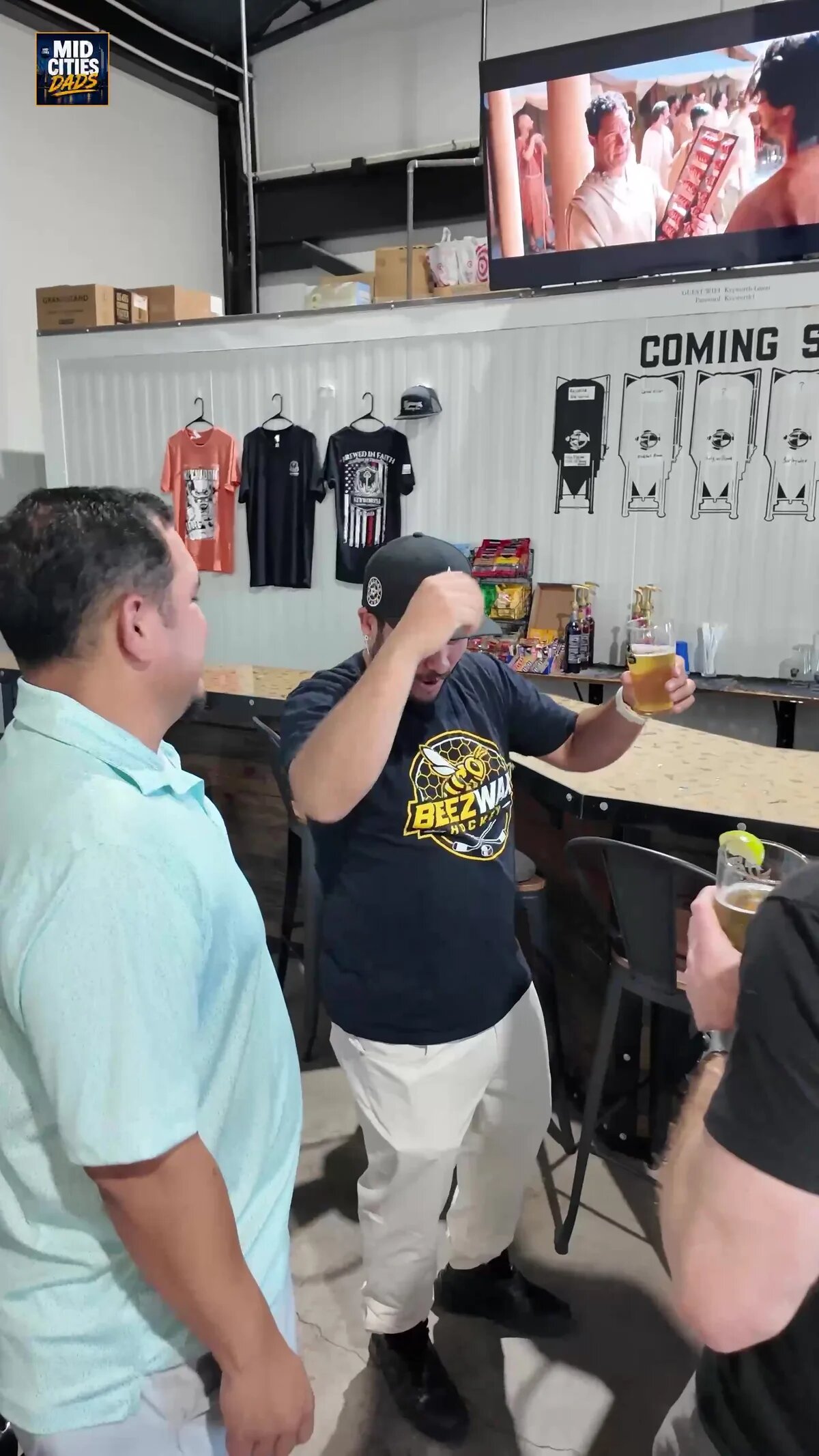 Dads raising their glasses beside the bar at Keyworth Brewing