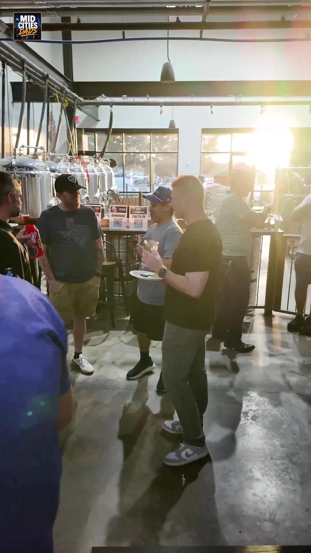 Dads gathered beside the brewing tanks at Keyworth Brewing