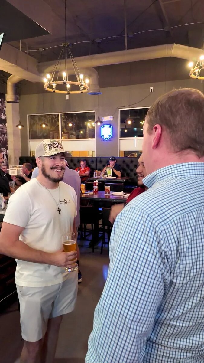 Dads catching up around a table at What's On Tap